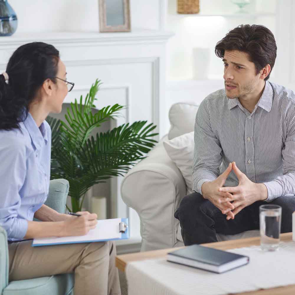 man speaking with therapist