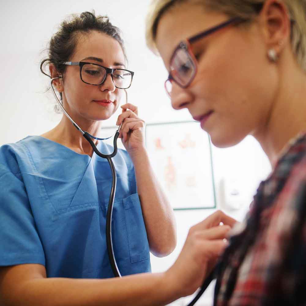 doctor checking patient with stethoscope