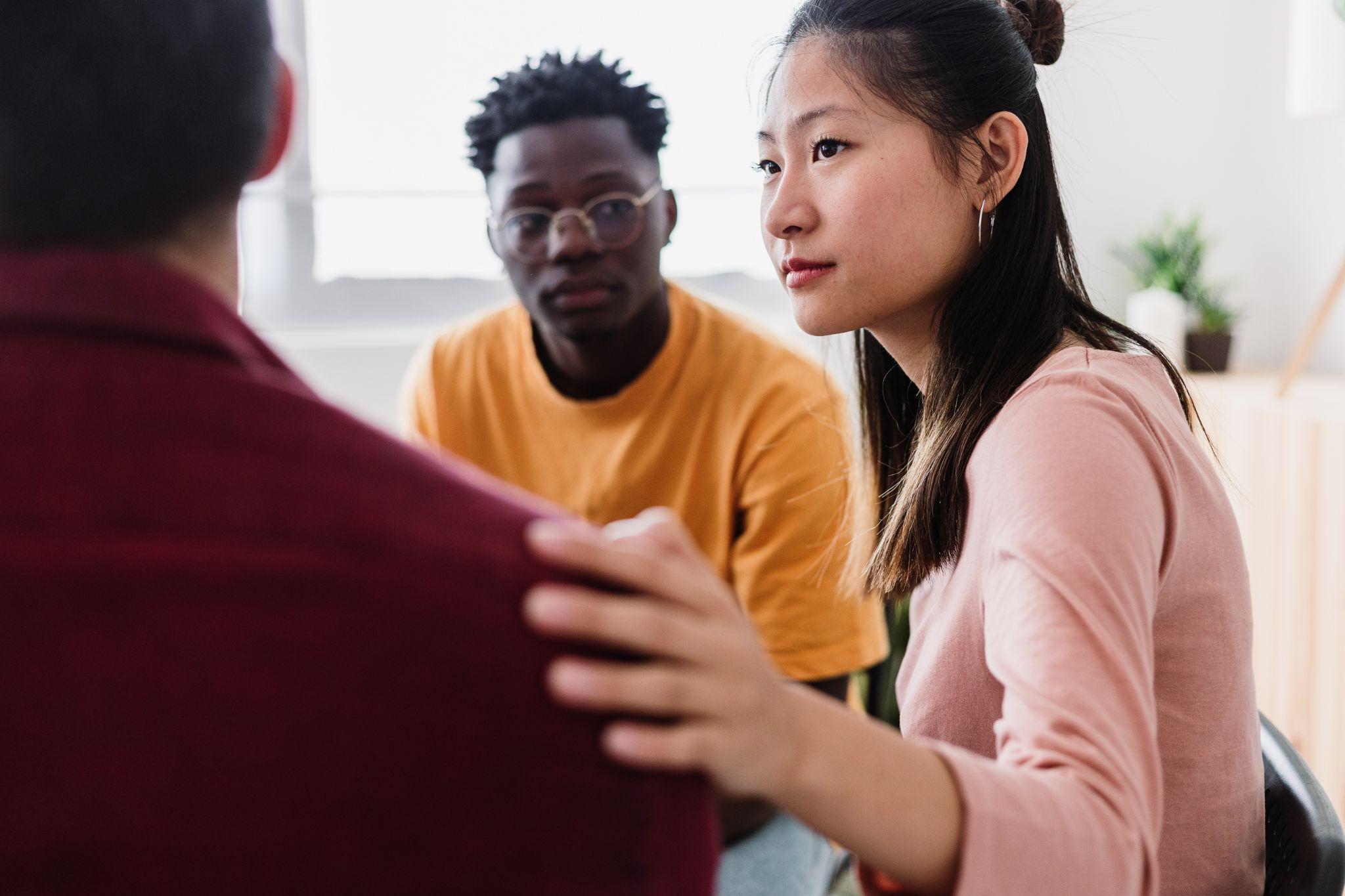 young adults consoling during therapy session