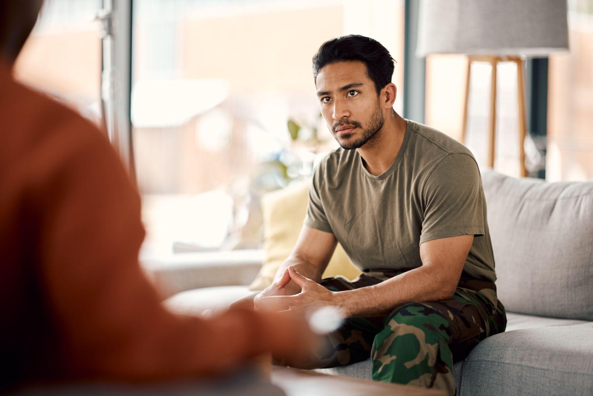 military man with trauma speaking to therapist