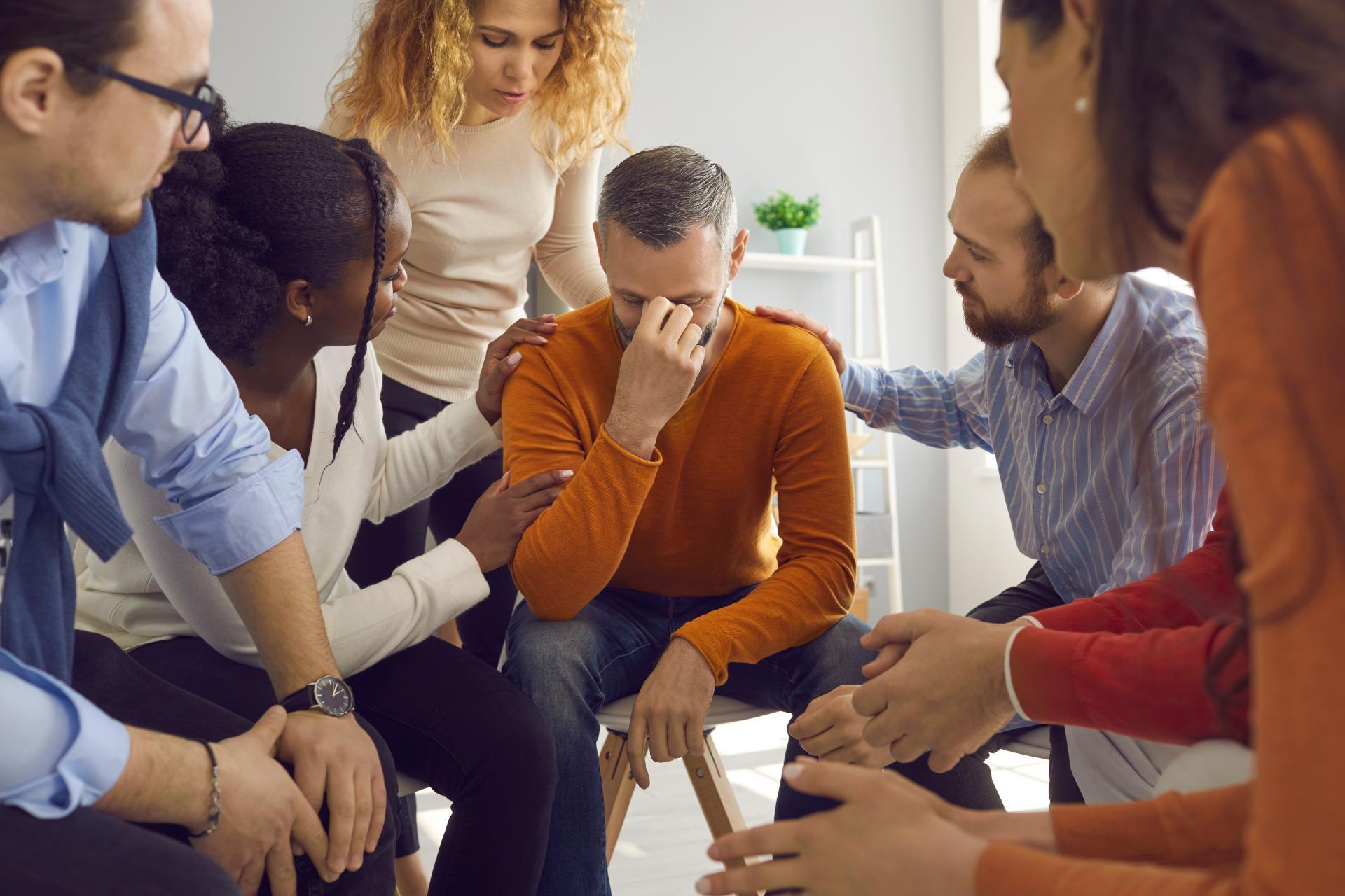 Diverse empathetic people in group therapy session